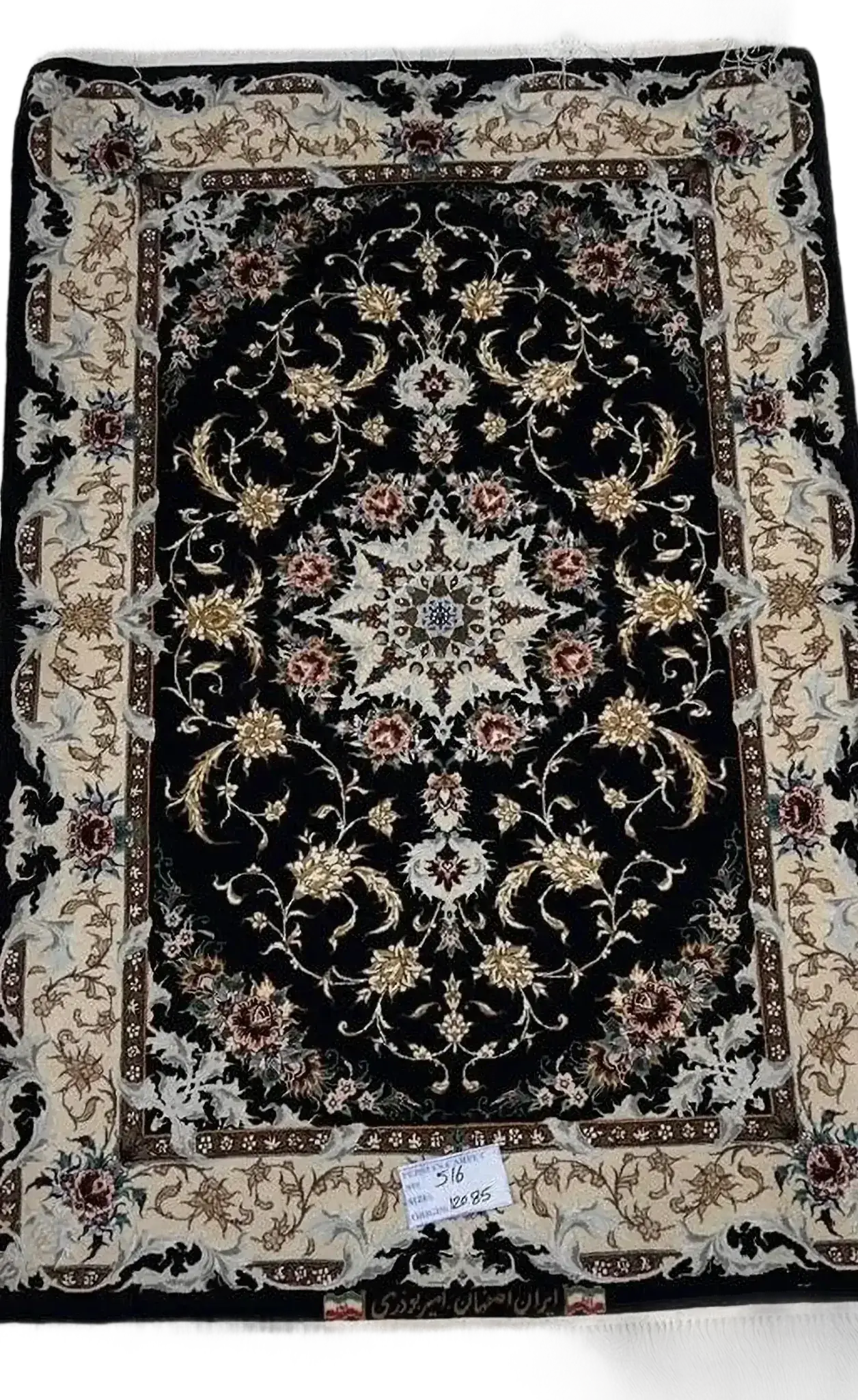 "Authentic Iranian carpet with intricate floral design in black, handwoven by Amir Buzarie"